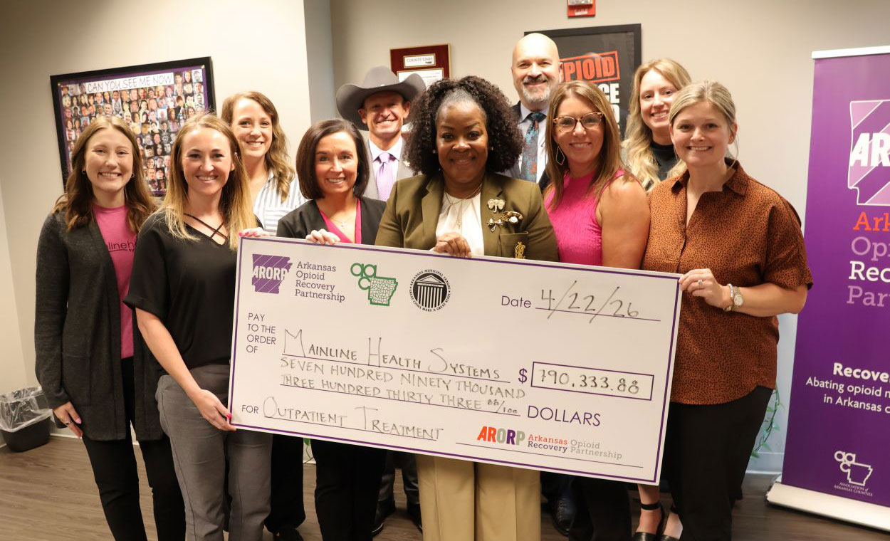 Mainline Health employees with check for opioid settlement